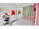 This decorated bedroom features a bed, a desk, and decorative vines at 228 Bergamot Loop, Davenport, FL 33837