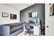 Bedroom featuring a dark accent wall, a comfortable bed, and a modern computer setup at 228 Bergamot Loop, Davenport, FL 33837