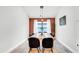 Well-lit dining room showcasing a wooden dining table and stylish black chairs at 228 Bergamot Loop, Davenport, FL 33837