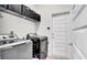 Laundry room featuring a washer, dryer, shelving, and a door to the exterior at 228 Bergamot Loop, Davenport, FL 33837