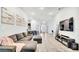 Open-concept living room with couch, tv and tile flooring at 228 Bergamot Loop, Davenport, FL 33837