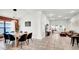 Open-concept living space seamlessly connecting dining area and living room, with lots of natural light at 228 Bergamot Loop, Davenport, FL 33837