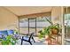 This is a screened patio with furniture and several potted plants at 228 Bergamot Loop, Davenport, FL 33837