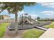 A community playground with multiple slides and activities, set in a safe, enclosed area at 228 Bergamot Loop, Davenport, FL 33837