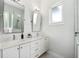 Bright bathroom features double sink vanity with marble countertops and tile flooring at 2407 Lafayette Ave, Winter Park, FL 32789
