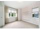 Bright bedroom with carpet, custom built-ins, and large window with a scenic view creates a cozy atmosphere at 2407 Lafayette Ave, Winter Park, FL 32789