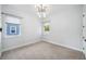 Cozy bedroom featuring neutral carpet, two windows, and modern light fixture for a relaxing space at 2407 Lafayette Ave, Winter Park, FL 32789