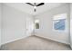 Minimalist bedroom with neutral carpet, two windows, and white walls creates a serene atmosphere at 2407 Lafayette Ave, Winter Park, FL 32789