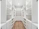 Spacious walk-in closet with custom shelving, drawers, and hardwood floors offers ample storage at 2407 Lafayette Ave, Winter Park, FL 32789