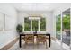 Bright dining room featuring a modern chandelier and views of lush greenery at 2407 Lafayette Ave, Winter Park, FL 32789