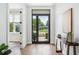 Bright entryway with hardwood floors, modern decor, and a view of the outdoors through a glass door at 2407 Lafayette Ave, Winter Park, FL 32789