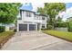 Charming two-story home boasts a modern design, manicured lawn, and a spacious driveway leading to the two-car garage at 2407 Lafayette Ave, Winter Park, FL 32789