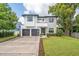 Striking two-story home with modern design, manicured lawn, and a spacious two-car garage at 2407 Lafayette Ave, Winter Park, FL 32789