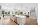 Bright and open kitchen flows to living area with island, modern design, and plenty of space at 2407 Lafayette Ave, Winter Park, FL 32789
