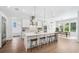 Open kitchen features a large island, modern appliances, and seamless flow into the dining area at 2407 Lafayette Ave, Winter Park, FL 32789