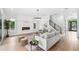 Open-concept living room with modern fireplace, staircase, and stylish decor at 2407 Lafayette Ave, Winter Park, FL 32789