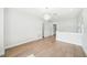 Spacious living room featuring wood floors, white walls, and a modern chandelier, perfect for entertaining at 2407 Lafayette Ave, Winter Park, FL 32789