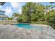 A backyard pool surrounded by a stone patio and a manicured privacy hedge at 2407 Lafayette Ave, Winter Park, FL 32789