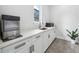 Wet bar features white cabinetry, stainless steel ice maker, and sink with modern faucet at 2407 Lafayette Ave, Winter Park, FL 32789