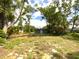 Large backyard surrounded by trees at 2414 E Orange Ave, Eustis, FL 32726