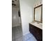 Bathroom features a dark wood vanity with a large mirror and tile floor at 2414 E Orange Ave, Eustis, FL 32726