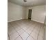 Bedroom featuring light-colored walls and tile flooring at 2414 E Orange Ave, Eustis, FL 32726