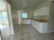 Kitchen with white cabinets, matching countertops, and tile flooring at 2414 E Orange Ave, Eustis, FL 32726