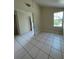 Living room featuring light-colored walls, tile floors and large window at 2414 E Orange Ave, Eustis, FL 32726