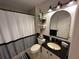 Bathroom featuring black and white accents, a vanity with a mirror, and a shower with a curtain at 243 Country Landing Blvd, Apopka, FL 32703