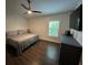 Bedroom features wood floors, ceiling fan, plantation shutters and updated dresser at 243 Country Landing Blvd, Apopka, FL 32703