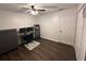 Bedroom with wood floors, ceiling fan, a window with blinds, and a black workstation area at 243 Country Landing Blvd, Apopka, FL 32703