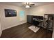 Bedroom with wood floors, ceiling fan, a window with blinds, and a black workstation area at 243 Country Landing Blvd, Apopka, FL 32703