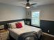 Bedroom with a comfortable queen bed, neutral patterned bedding, a ceiling fan and window with shutter at 243 Country Landing Blvd, Apopka, FL 32703