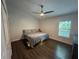 Bedroom features wood floors, ceiling fan and plantation shutters at 243 Country Landing Blvd, Apopka, FL 32703