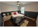 Bedroom featuring a queen bed, ceiling fan, wood floors, and natural light from the window at 243 Country Landing Blvd, Apopka, FL 32703