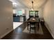 Open dining room features dark wood floors, stylish light fixture, and seamless transition to the kitchen at 243 Country Landing Blvd, Apopka, FL 32703