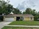 Charming yellow single-Gathering home with a well-maintained lawn and a two car garage at 243 Country Landing Blvd, Apopka, FL 32703