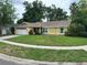 Attractive yellow single-Gathering home with a manicured lawn and a two car garage at 243 Country Landing Blvd, Apopka, FL 32703