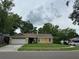 Inviting yellow single-Gathering home with a well-kept lawn and a two-car garage at 243 Country Landing Blvd, Apopka, FL 32703