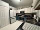 Modern kitchen with white and blue cabinets, stainless steel appliances, and ample counter space at 243 Country Landing Blvd, Apopka, FL 32703