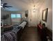 Cozy living room featuring hardwood floors, a comfortable leather couch and plantation shutters at 243 Country Landing Blvd, Apopka, FL 32703