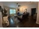 Inviting living room featuring hardwood floors, a leather couch, and stylish furnishings at 243 Country Landing Blvd, Apopka, FL 32703