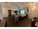 Open-concept living room with hardwood floors, a leather couch, and ample natural light at 243 Country Landing Blvd, Apopka, FL 32703
