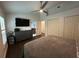 Main bedroom has wood floors, ceiling fan, closet, and modern dresser, seamlessly connects to the ensuite bathroom at 243 Country Landing Blvd, Apopka, FL 32703