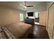 Spacious main bedroom with wood floors, ceiling fan, ensuite access, and updated dresser at 243 Country Landing Blvd, Apopka, FL 32703