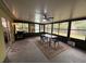 Enclosed patio featuring a ceiling fan, outdoor dining set, and a black and white rug at 243 Country Landing Blvd, Apopka, FL 32703