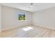 Large bedroom with light wood-look flooring and natural light from a large window at 2550 Barren Oak Ct, Deland, FL 32720