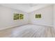 Large bedroom with light wood-look flooring, vaulted ceilings, and ample sunlight at 2550 Barren Oak Ct, Deland, FL 32720