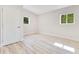 Neutral bedroom featuring light wood-look flooring and two sunny windows at 2550 Barren Oak Ct, Deland, FL 32720