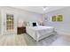 Bedroom with a large bed, wood floors, and natural light coming through the windows at 2550 Barren Oak Ct, Deland, FL 32720